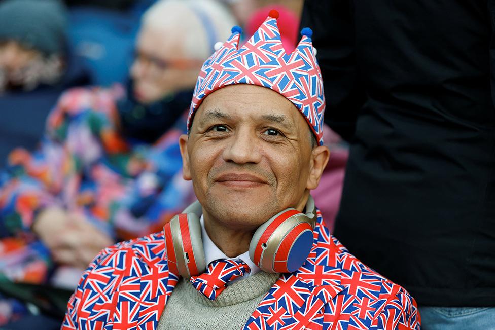 A man waits to watch the procession